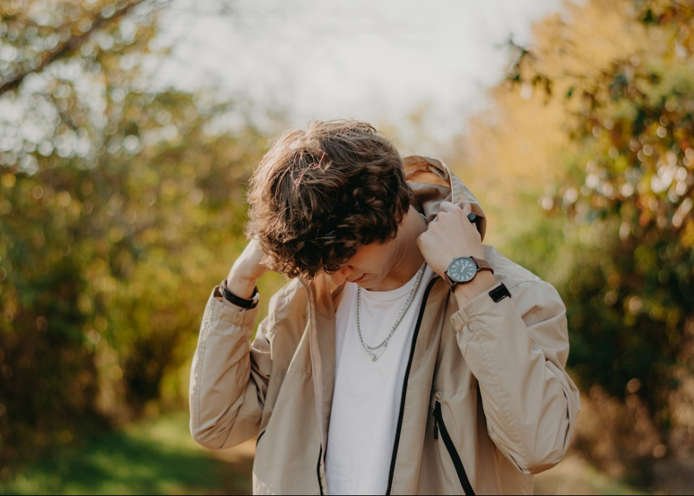 How to Protect Your Skin While Gardening - man coving his head with hoody